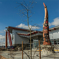 A large loon, carved from a 300-year-old red cedar that stands at the entrance of the Songhees Wellness.
