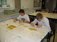 Kids working on Spaghetti Bridge at DiscoverTech