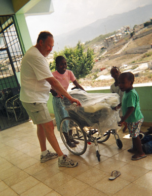 Henry Mark unwrapping chair with friends.