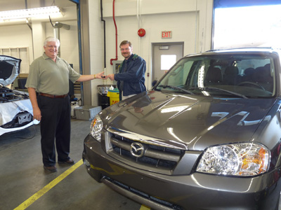 Mazda Canada’s George Benda hands-over keys of a 2005 Mazda Tribute to Trades and Technology Dean Dr. Tom Roemer