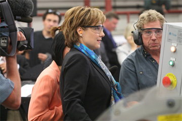Premier Clark receives a quick lesson on the Water Jet Cutter from Ken McDonald, Sheet Metal program leader.