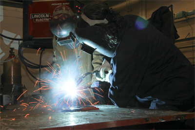 Attendee tries out welding at the Trades Awareness conference.